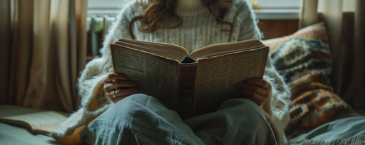 Woman reading handwritten letter by warm lamplight - cozy mystery storytelling experience