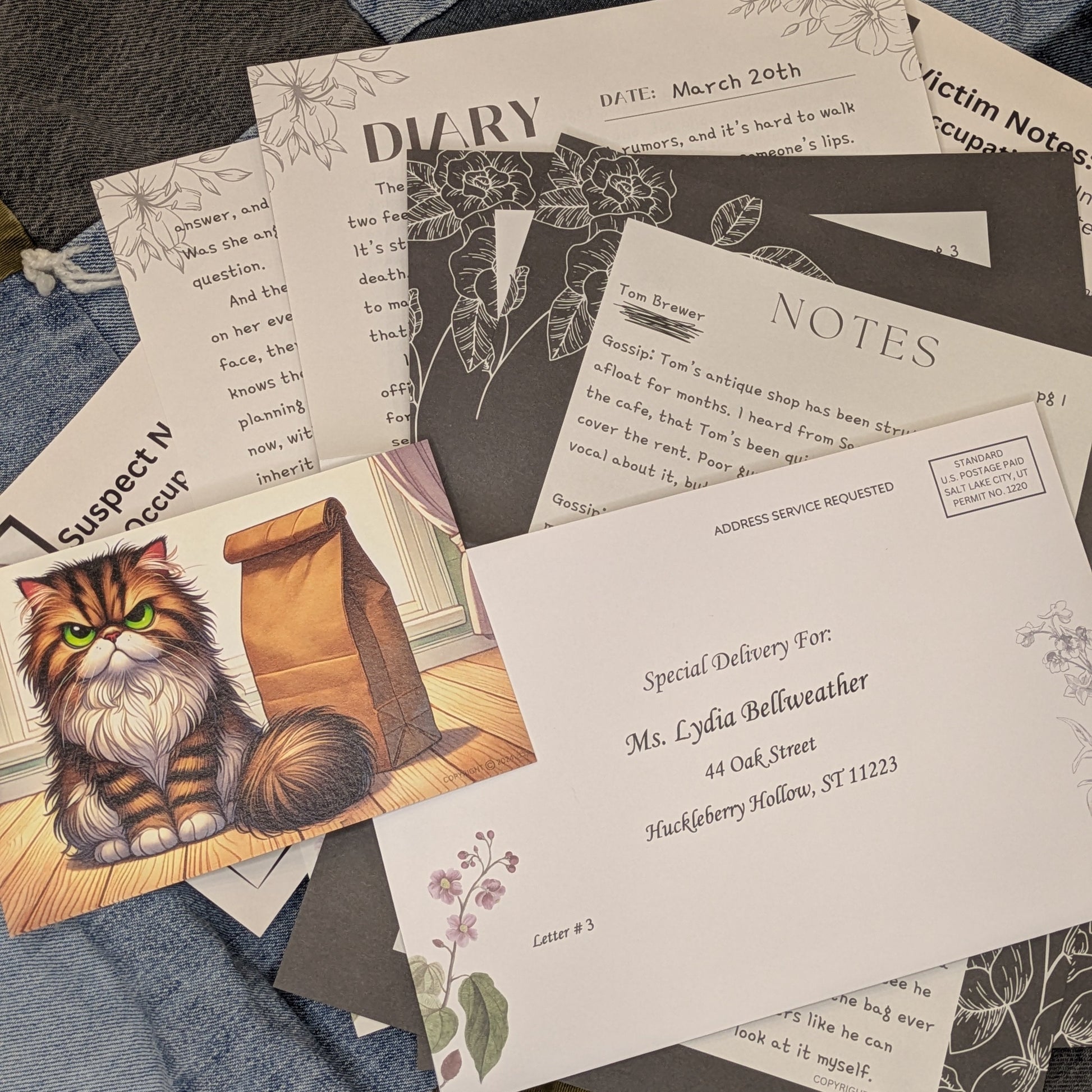 Letter 3 of the 12-month Cozy Mystery open on a denim quilt