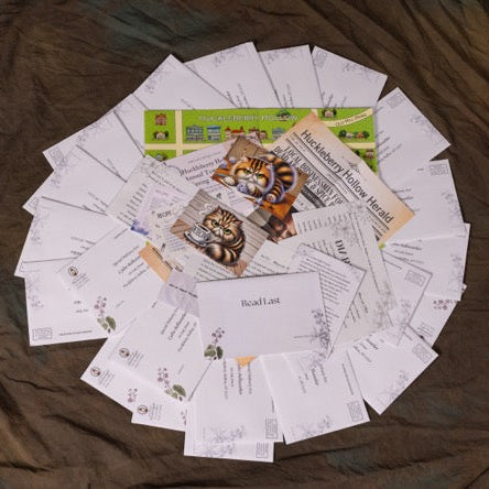 Collection of printed materials including letters and postcards on a wooden surface