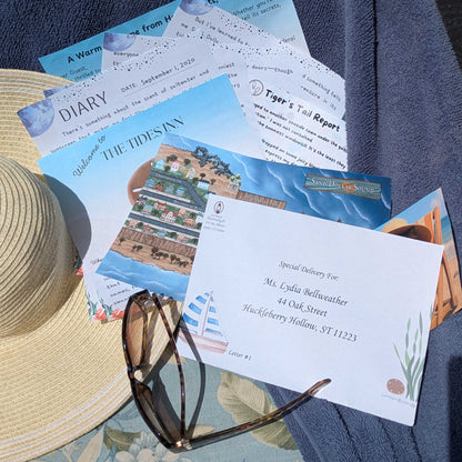 The contents of letter 1 of The Vanishing Compass 12 month cozy mystery by mail displayed on top of a straw sun hat, all on a blue floral bench cushion with a blue beach towel behind and sunglasses on top 